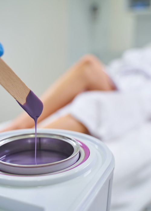 Close up of cosmetologist that heating wax